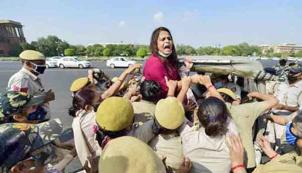 women surrounded by police and shouting